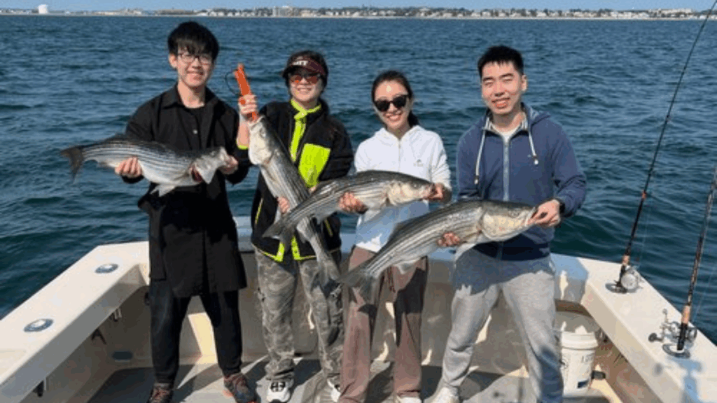 4 people holding their catched fish