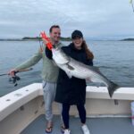 A couple holding up a big fish
